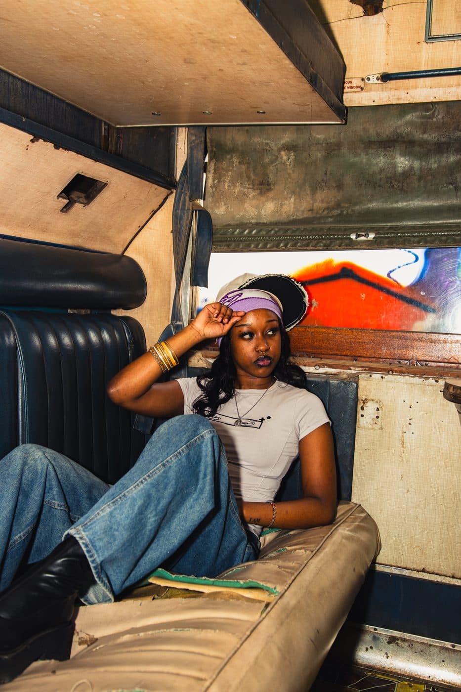 Inside the carriage, headwrap and worn upholstery