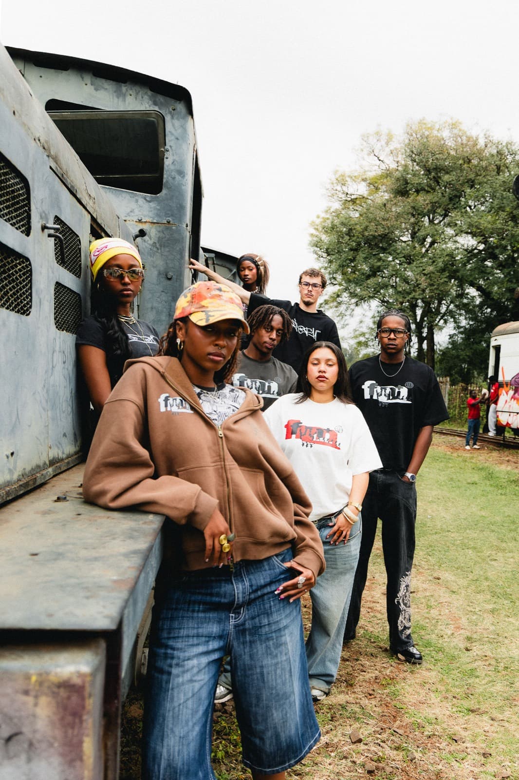 The fm+ collective in the Nairobi train yard, wearing the Summer 2026 collection.